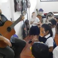 Mauricio Gutiérrez cantando con estudiantes